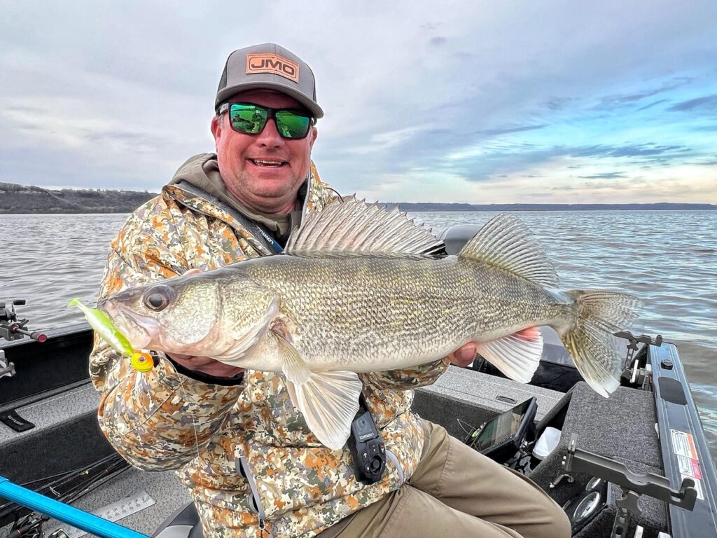 Angler holding a fall walleye caught with an Eye Candy Paddle Shad lure.